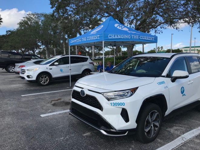 A Florida Power & Light tent and vehicles set up in the Miracle Mile shopping corridor of Vero Beach  served as what the company calls an "outage relief site" where residents without power can charge devices, access Wi-Fi and speak with its "community response team," said FPL spokesperson Peter Robbins.