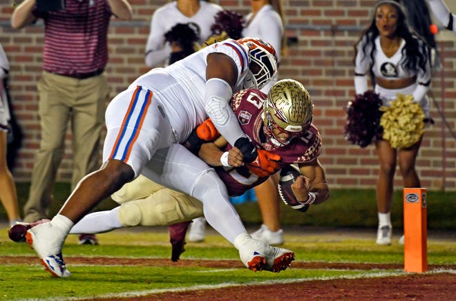 FSU quarterback Jordan Travis scores on a run during the first half against Florida.