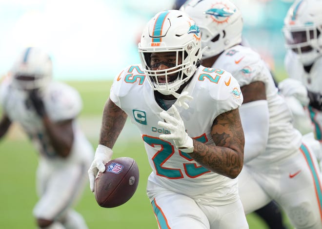 Dolphins cornerback Xavien Howard returns a fumble recovery for a touchdown during the second quarter of Sunday's win against the Texans.