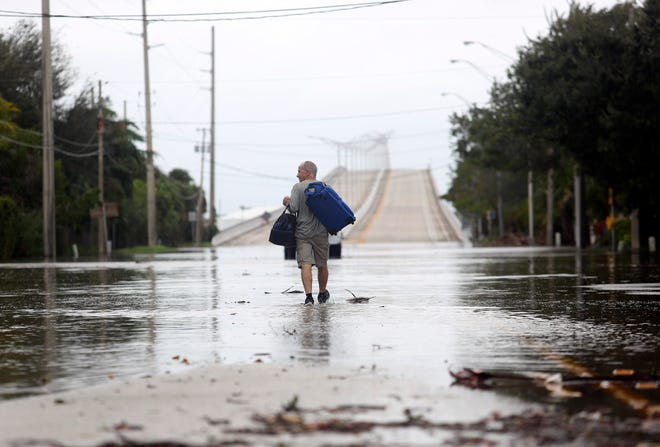 The east side of the Alma Lee Loy Bridge experienced flooding Thursday, Nov. 10, 2022, after Hurricane Nicole made landfall in Vero Beach. Law enforcement blocked both sides of the bridge from regular traffic, allowing residents to drive through.