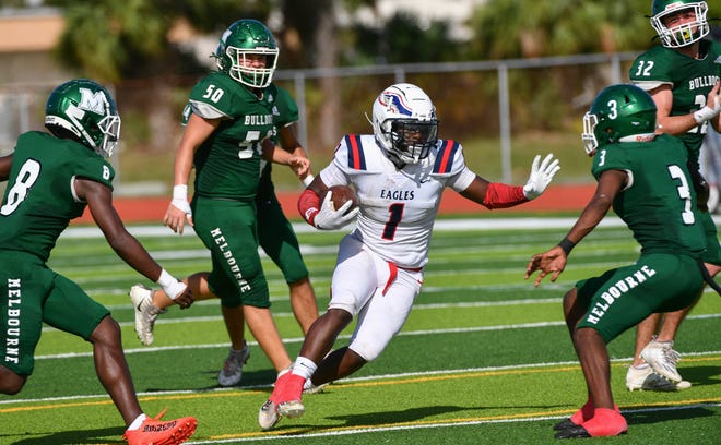 Ricky Cooper of Centennial is surrounded by Melbourne defenders in their first round game of the FHSAA Class 4S football championship Saturday, November 12, 2022. Craig Bailey/FLORIDA TODAY via USA TODAY NETWORK