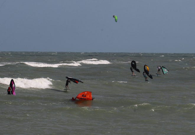 Kite surfers and wing foilers take advantage of the wind and waves along Fort Pierce Beach at Fort Pierce jetty Park on Monday, Nov. 7, 2022, in Fort Pierce as recently developed Subtropical Storm Nicole aims eastward towards the Treasure Coast.