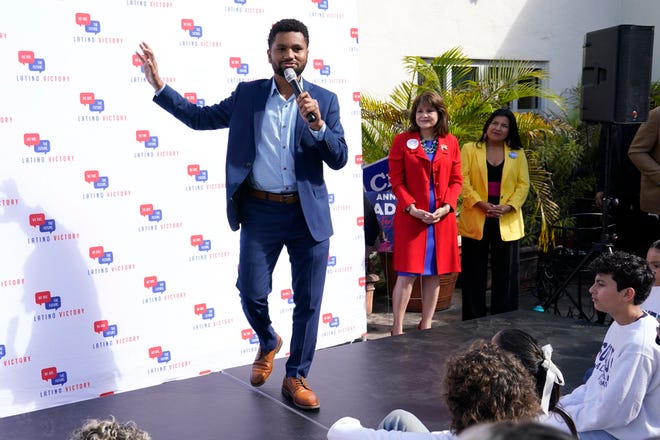 Maxwell Frost, Democratic Congressional candidate for District 10, speaks during a rally held by the Latino Victory Fund, Thursday, Oct. 20, 2022, in Coral Gables, Fla. The midterm elections are November 8. At center is Florida state Sen. Annette Taddeo, and right, is Karla Hernandez-Mats, running mate to Florida Democratic gubernatorial candidate Charlie Crist.
