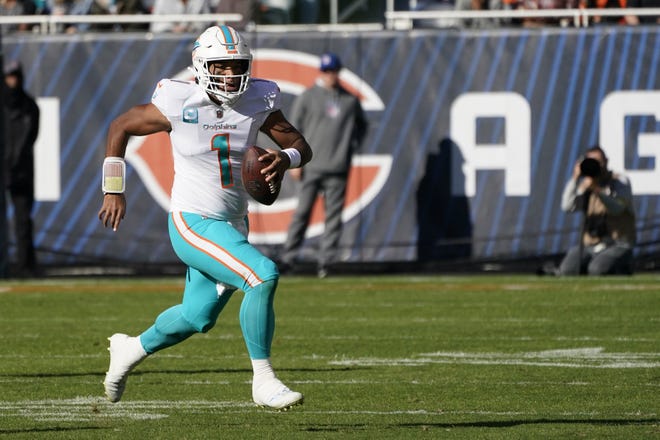 Miami Dolphins quarterback Tua Tagovailoa scrambles with the ball during the first half of an NFL football game against the Chicago Bears, Sunday, Nov. 6, 2022 in Chicago. (AP Photo/Charles Rex Arbogast)