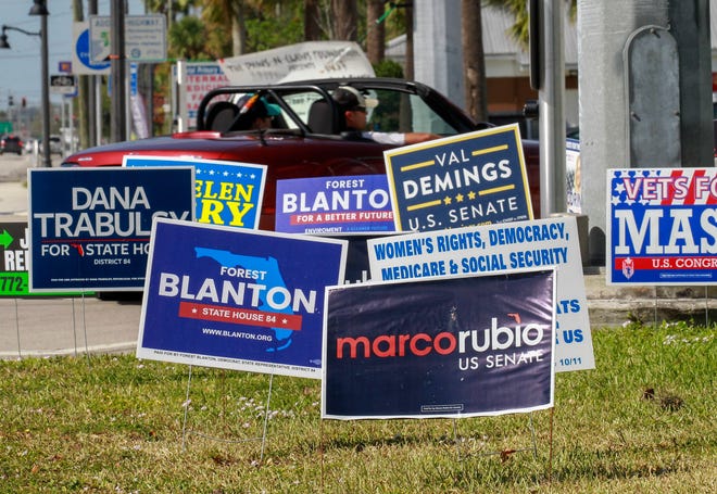 Campaign signs along U.S. 1 at the intersection of Midway Road are seen on Monday, November 7, 2022, as a reminder for election day voters to cast their ballots at their voting precincts.