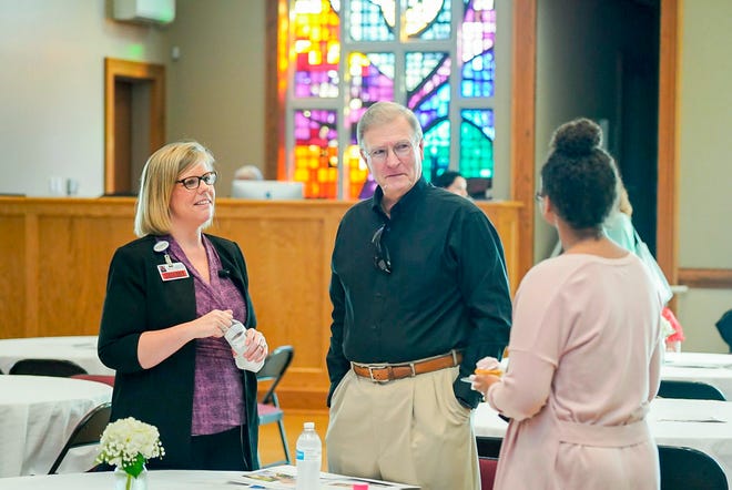 Following a community-wide presentation of teh Mother-Baby Project, Cleveland Clinic Indian River Hospital Director of Women's Health Megan McFall and Indian River County Hospital District Treasurer Allen Jones discuss the renovation with an attendee.