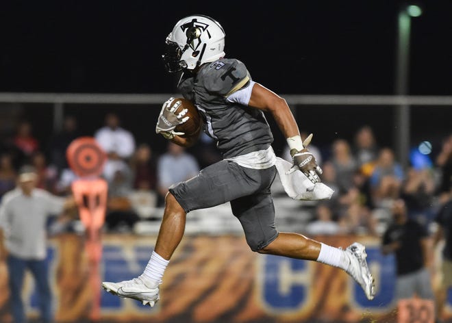 Treasure Coast's Melik Cooper (3) rushes in a 36-yard touchdown during the second quarter in a Region 3-4S quarterfinal football game against Martin County on Friday, Nov. 11, 2022, in Stuart. Treasure Coast won 35-7.