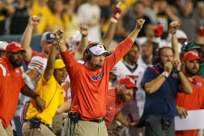 Liberty coach Hugh Freeze celebrates after the Flames stopped Southern Miss on the goal line to defeat the Golden Eagles in overtime in September.