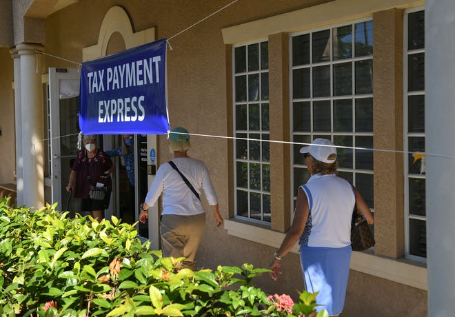 Customers inquire about issues with the locked tag office of the Martin County Tax Collector offices at the Willoughby Commons office buildings, leaving them to unable to update their license plates on Monday, Nov. 1, 2021 in Stuart.