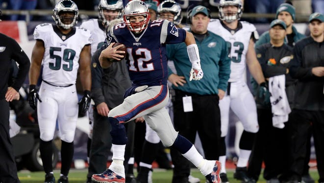 New England Patriots quarterback Tom Brady (12) runs along the sideline after catching a pass from Danny Amendola during the second half against the Philadelphia Eagles on  Dec. 6, 2015.