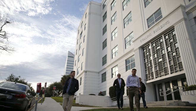 People leave the Collins Building, office of the Attorney General and Department of Legal Affairs, on a December afternoon in 2017.