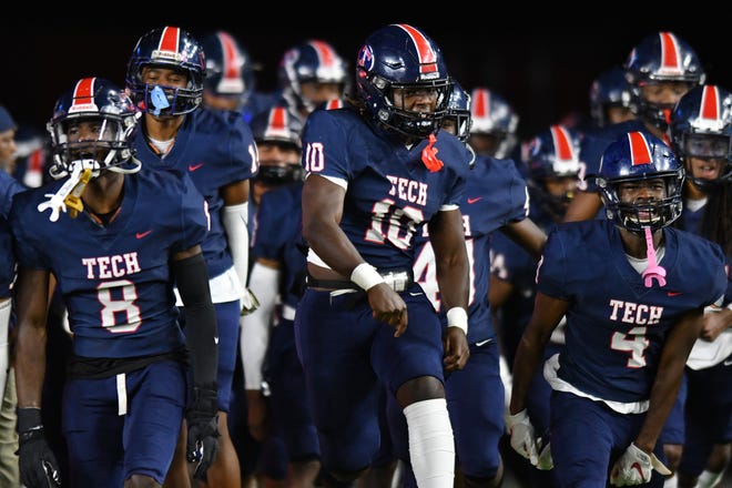Edward Gwinn of Tampa Bay Tech leads his team on the field to take on St. Thomas Aquinas in the Class 7A state championship game at DRV PNK Stadium, Fort Lauderdale, FL  Dec. 17, 2021.