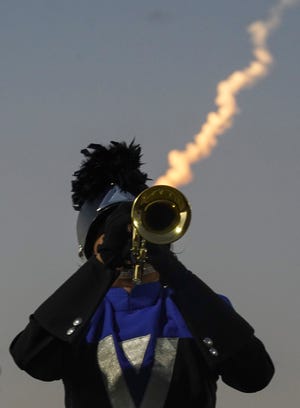 The remnants of a SpaceX Falcon 9 launch is seen in the sky as Wellington High School marching band and color guard perform during the 41st annual Crown Jewel Marching Band Festival on Saturday, Oct. 8, 2022, at Vero Beach High School. The Crown Jewel is one of the oldest continuous marching festivals in Florida.