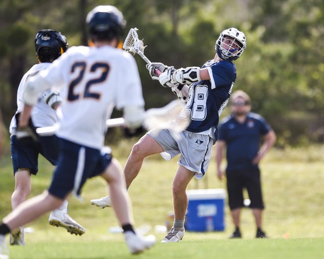 St. Edward's Ford Norris (28) scores a goal against The Pine School in a high school boys lacrosse game Tuesday, March 22, 2022, at The Pine School in Hobe Sound. St. Edward's won 15-1.