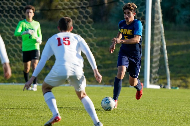 The Pine School’s Julian Restrepo (5) runs the ball against All Saints Academy in the 2-2A boys soccer regional semifinal Monday, Feb. 14, 2022, at The Pine School in Hobe Sound. The Pine School won 7-1.