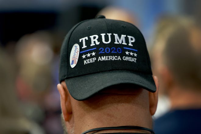 A voter wears a Trump hat as he attends a campaign event for Florida Gov. Ron DeSantis held at the American Top Team on November 04, 2022 in Coconut Creek, Florida.