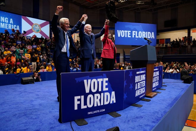 President Joe Biden is joined on stage by Florida gubernatorial candidate Rep. Charlie Crist, D-Fla., left, and Senate candidate Rep. Val Demings, D-Fla., during a campaign rally at Florida Memorial University, Tuesday, Nov. 1, 2022, in Miami Gardens, Fla. (AP Photo/Evan Vucci)