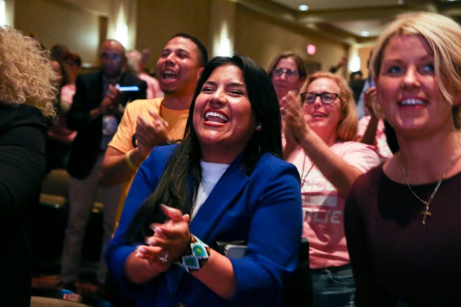 Karla Hernandez (center), running mate for Democratic gubernatorial candidate Charlie Crist, cheers as Crist walks on stage before the debate, Monday, Oct. 24, 2022, at Sunrise Theatre in Fort Pierce.