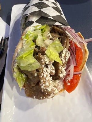 The Beef/Lamb Gyro featured marinated meat piled into a warm pita and garnished with lettuce, tomatoes, and tzatziki sauce.