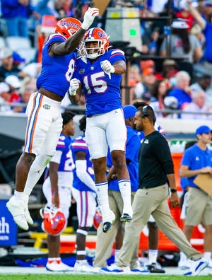 Florida linebackers Derek Wingo (15) and Khris Bogle (8) celebrate a fumble recovery against Georgia last season.