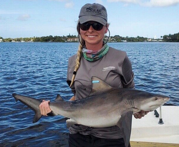 Michelle Edwards of Florida Atlantic University's Harbor Branch Oceanographic Institute has a juvenile bull shark caught in the Indian River Lagoon.