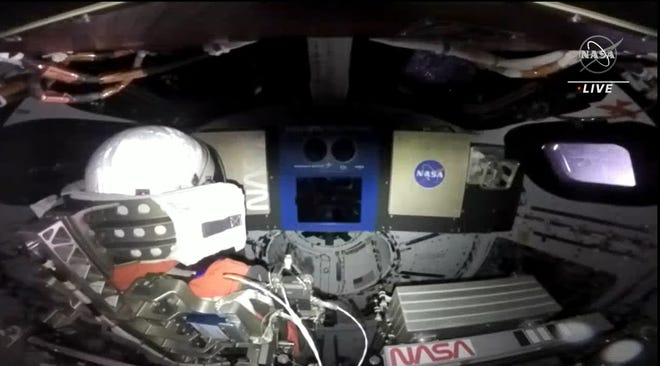 In this screen capture, NASA shares a view from inside the moon-bound Artemis I Orion spacecraft. It shows a mannequin outfitted in NASA's newest Orion Crew Survival spacesuit. It's the spacesuit that the crew will wear during the first crewed mission to the moon, Artemis II.
