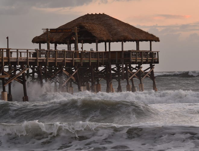 Subtropical Storm Nicole and the full moon generate big waves and high surf Tuesday morning at the Cocoa Beach Pier.