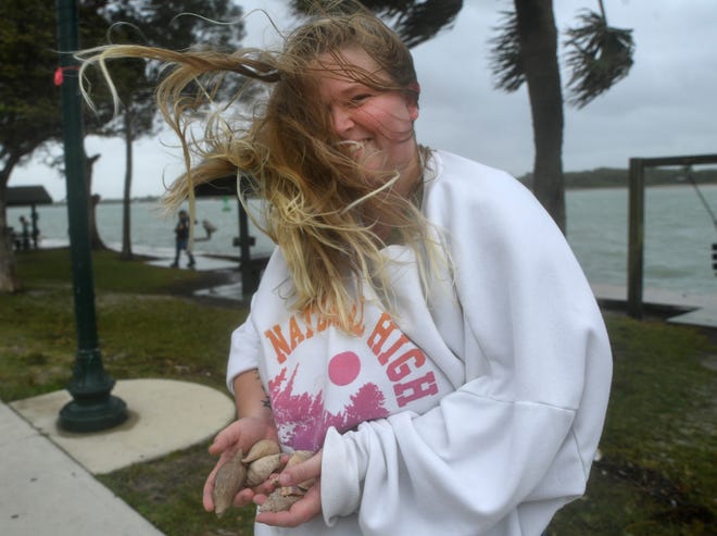 Samantha Kabina, of Fort Pierce, holds on to shells churned up from the outgoing tide and washed up onto the sidewalk along the south side the Fort Pierce inlet as the wind and waves ahead of Tropical Storm Nicole blast the Treasure Coast on Wednesday, Nov. 9, 2022 in Fort Pierce. "It's crazy, it could be worse though it's nice, I miss the storms," Kabina said. " was here for (hurricanes) Jeanne, Frances, Katrina, I was born and raised in south Florida."