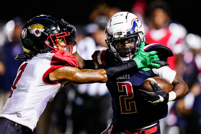 Centennial’s wide receiver Zeqan Wright (2) fends off a tackle against Port St. Lucie in a high school football game on Friday, Nov. 4, 2022, at South County Regional Stadium. Centennial won 59-0.