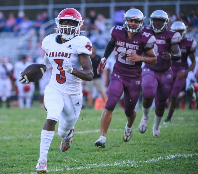 Forest Hill's Andrew Davis (3) runs the ball in for a touchdown while being chased by Lake Worth's Enzo Storani (22) during the second quarter of the football game between Forest Hill and host Lake Worth on Friday, September 23, 2022, in Lake Worth Beach, FL.