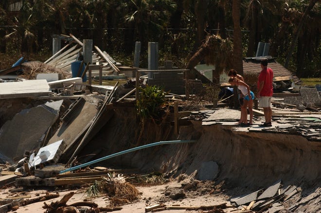 After being allowed to return to the barrier island, many people took time to view the destruction caused by Hurricane Jeanne, which caused even more damage at Wabasso Beach Park seen here Sept. 28, 2004, in Indian River County.