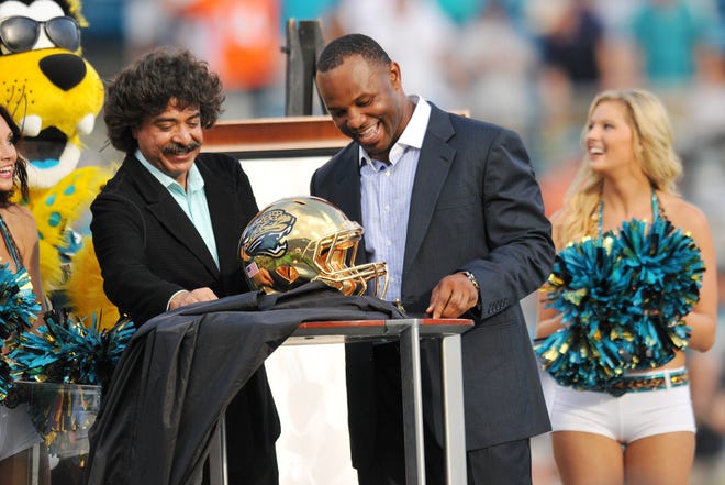 Sept. 30, 2012: Bob.Self@jacksonville.com--9/30/12--Jaguar's owner Shad Khan presents Fred Taylor with a gold Jaguar helmet as he was inducted into the Jaguar's Ring of pride during Sunday's game.  The Jacksonville Jaguars took on the Cincinnati Bengals at EverBank Field in Jacksonville, FL Sunday, September 30, 2012.  The Jaguars lost with a final score of 27 to 10.  (The Florida Times-Union, Bob Self)