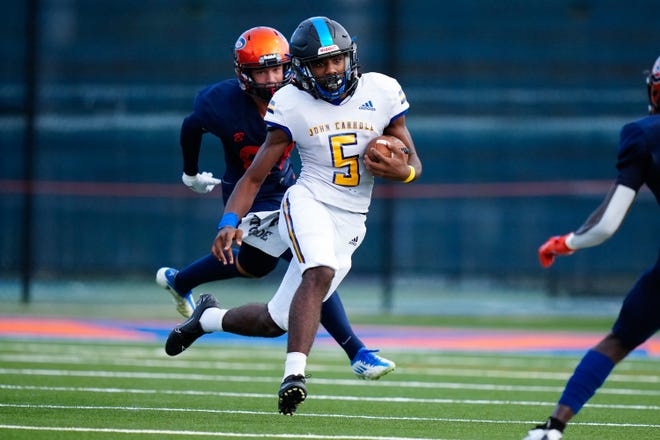 John Carroll Catholic running back Tony Colebrook (5) runs the ball against Benjamin High School in a high school football game on Thursday, Aug. 25, 2022 at Benjamin High School in Palm Beach. John Carroll won 24-21.