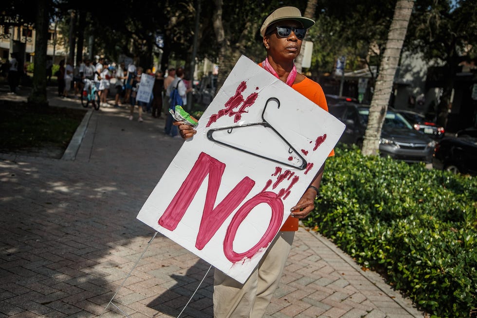 A protester carries a sign outside Old School Square in Delray Beach after the U.S. Supreme Court's reversal of Roe v. Wade in June. Black women are nearly four times as likely to die as a result of pregnancy as white women in Palm Beach County.