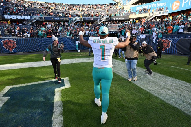 Nov 6, 2022; Chicago, Illinois, USA;  Miami Dolphins quarterback Tua Tagovailoa (1) heads to the locker room after defeating the Chicago Bears 35-32 at Soldier Field. Mandatory Credit: Jamie Sabau-USA TODAY Sports