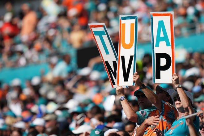 Nov 27, 2022; Miami Gardens, Florida, USA; Miami Dolphins fans hold up a MVP sign for Miami Dolphins quarterback Tua Tagovailoa (not pictured) during the first half against the Houston Texans at Hard Rock Stadium. Mandatory Credit: Jasen Vinlove-USA TODAY Sports