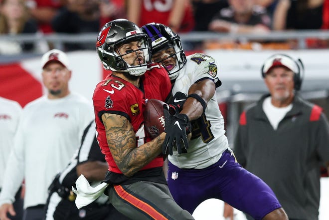 Oct 27, 2022; Tampa, Florida, USA;  Tampa Bay Buccaneers wide receiver Mike Evans (13) catches a pass defended by Baltimore Ravens cornerback Marlon Humphrey (44) in the fourth quarter at Raymond James Stadium. Mandatory Credit: Nathan Ray Seebeck-USA TODAY Sports