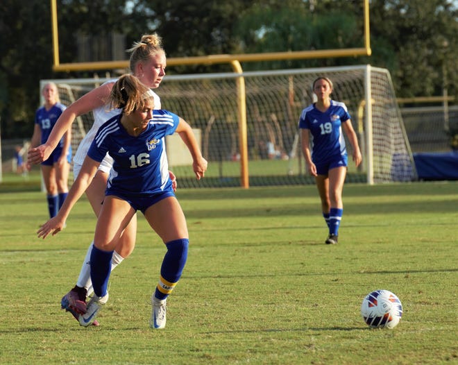 Martin County's Kacey O'Donnell and Treasure Coast's Findley Wessel battle for the ball during a high school soccer match on Tuesday, Nov. 15, 2022 at Martin County High School in Stuart. The Titans won the match 4-0.
