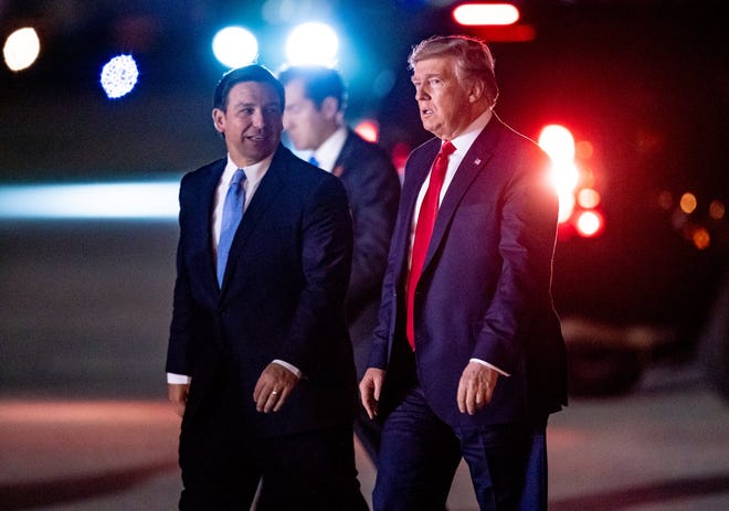 Happier times together: Then-President Donald Trump arrives on Air Force One and is greeted by Gov.Ron DeSantis at Palm Beach International Airport in West Palm Beach on November 26, 2019.
