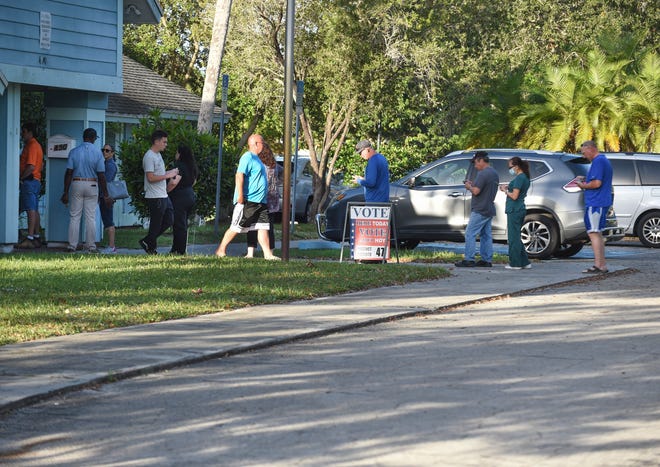 A line of voters is seen waiting to vote along with voters exiting after casting their ballots at Precinct 47, the Windmill Point clubhouse, 490 SW Kentwood Road, within the first hour after the polls opened on Tuesday, Nov. 8, 2022, in Port St. Lucie.