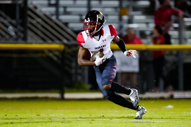 Port St. Lucie’s wide receiver Robert Tatum (4) runs the ball against Centennial in a high school football game on Friday, Nov. 4, 2022, at South County Regional Stadium. Centennial won 59-0.