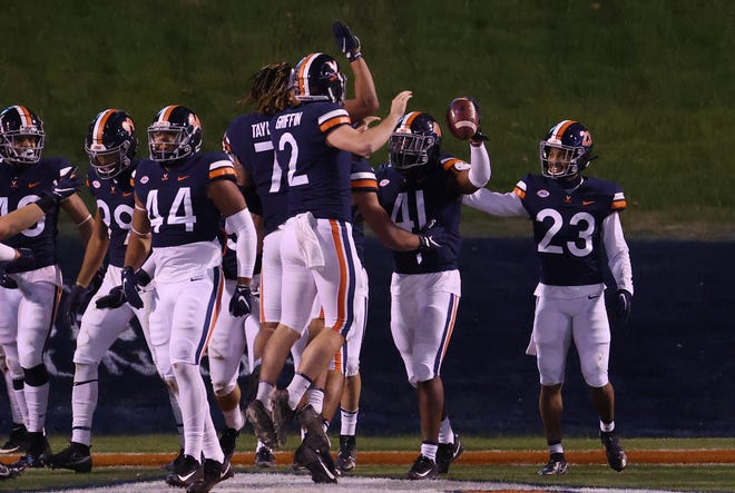 Virginia linebacker D'Sean Perry (41) celebrates with teammates after returning an interception for a touchdown against the Abilene Christian.