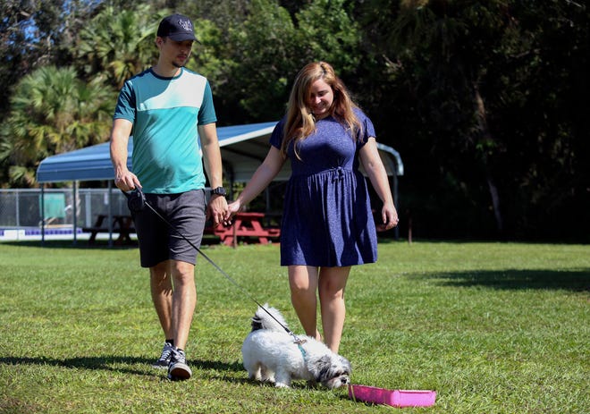 Hector Hernandez with his girlfriend Gabriella Gonzalez and their dog, Coco, in Fort Pierce on Tuesday, Oct. 25, 2022. The couple embarked on a 22-day journey to the U.S., caravanning through Nicaragua, Honduras, Guatemala and Mexico, leaving their friends and family behind in Cuba.