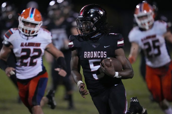 Ahmad Haston (5) of Palm Beach Central breaks free for a big gain against Palm Beach Gardens during the first half of the 4M Regional Final on Friday, Nov. 25, 2022 in Wellington.