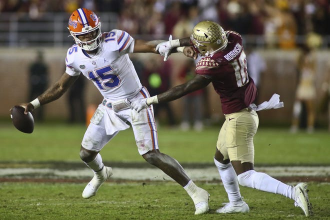Florida quarterback Anthony Richardson (15), trying to get away from Florida State defensive back Jammie Robinson (10) on the last play of FSU's 45-38 victory, is likely headed to the NFL, but would be well-served to stay in college one more year and polish up his accuracy issues.