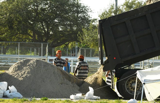 Sandbag distribution at Wickham Park in Melbourne on Tuesday morning. The line was already long with citizens preparing for the coming weather.