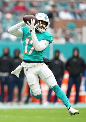 Dec 25, 2022; Miami Gardens, Florida, USA; Miami Dolphins wide receiver Jaylen Waddle (17) makes a catch before running for a touchdown against the Green Bay Packers during the first half at Hard Rock Stadium. Mandatory Credit: Jasen Vinlove-USA TODAY Sports