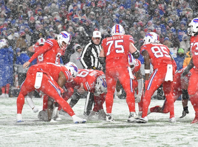 Dec 17, 2022; Orchard Park, New York, USA; Buffalo Bills players clear an area on the field to prepare for a winning field goal attempt against the Miami Dolphins in the fourth quarter at Highmark Stadium. Mandatory Credit: Mark Konezny-USA TODAY Sports