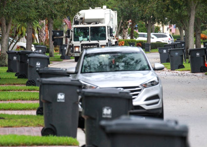 An FCC Environmental Services automated side-loading garbage truck is seen making it's collection of trash along Montserrad Place in the VillageWalk neighborhood on Monday, Aug. 29, 2022, in Wellington. All garbage should be place in the approved garbage carts and not piled up curbside.