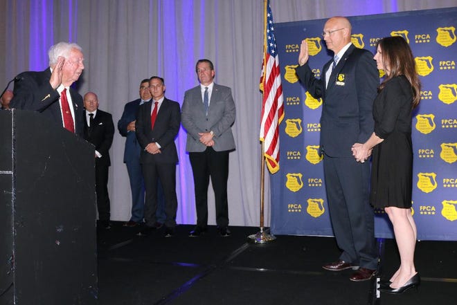 Fellsmere Police Chief Keith Touchberry is sworn in as president of the Florida Police Chiefs Association by Fellsmere Mayor Joel Tyson.